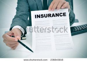 stock-photo-a-young-man-in-suit-in-his-office-showing-an-insurance-policy-and-pointing-with-a-pen-where-the-236845816